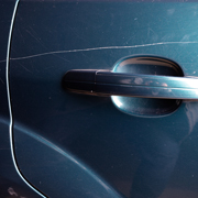 close up of a car door handle with scratch damage showing the importance of maintenance and protection for automotive surfaces 5 key tips