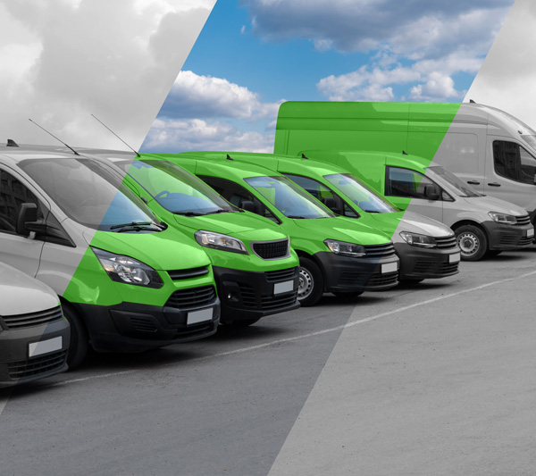 a row of vehicles featuring five green vans and several gray ones under a cloudy sky