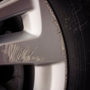 scratched car wheel close up showing damage tire three repair options