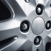 close up of a silver car wheel rim with bolts showcasing a sleek design and finish relevant for automotive enthusiasts and car maintenance